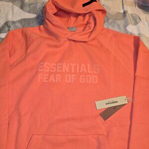 Fear of God Essentials Hoodie in Coral—a standout, soft-pink hue unisex oversize